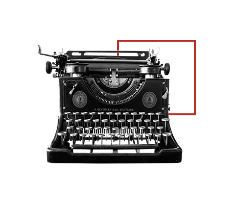 machine à écrire devant cadre rouge